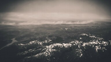 cached/dharmx_walls/aerial/a_aerial_view_of_a_snowy_mountain_range.jpg