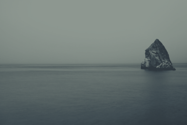 cached/dharmx_walls/apeiros/a_large_rock_in_the_middle_of_a_body_of_water.png