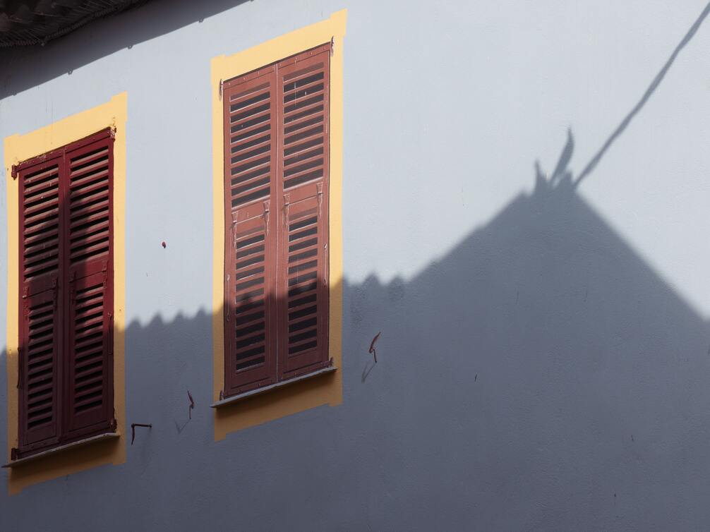 cached/dharmx_walls/architecture/a_building_with_shutters_on_windows.jpg