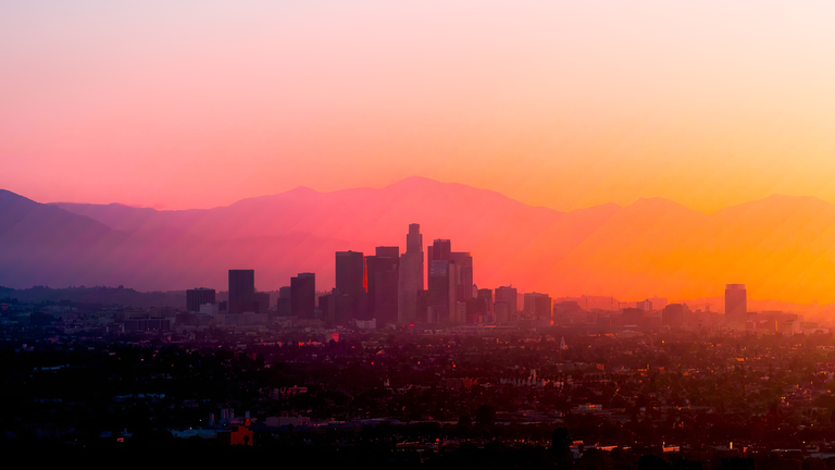 cached/dharmx_walls/architecture/a_city_skyline_with_mountains_in_the_background.png