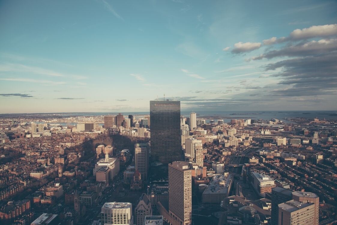 cached/dharmx_walls/architecture/a_city_with_tall_buildings_and_water_in_the_background.jpg