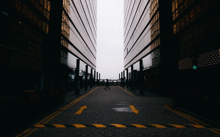 cached/dharmx_walls/architecture/a_person_walking_on_a_street_between_two_tall_buildings.jpg