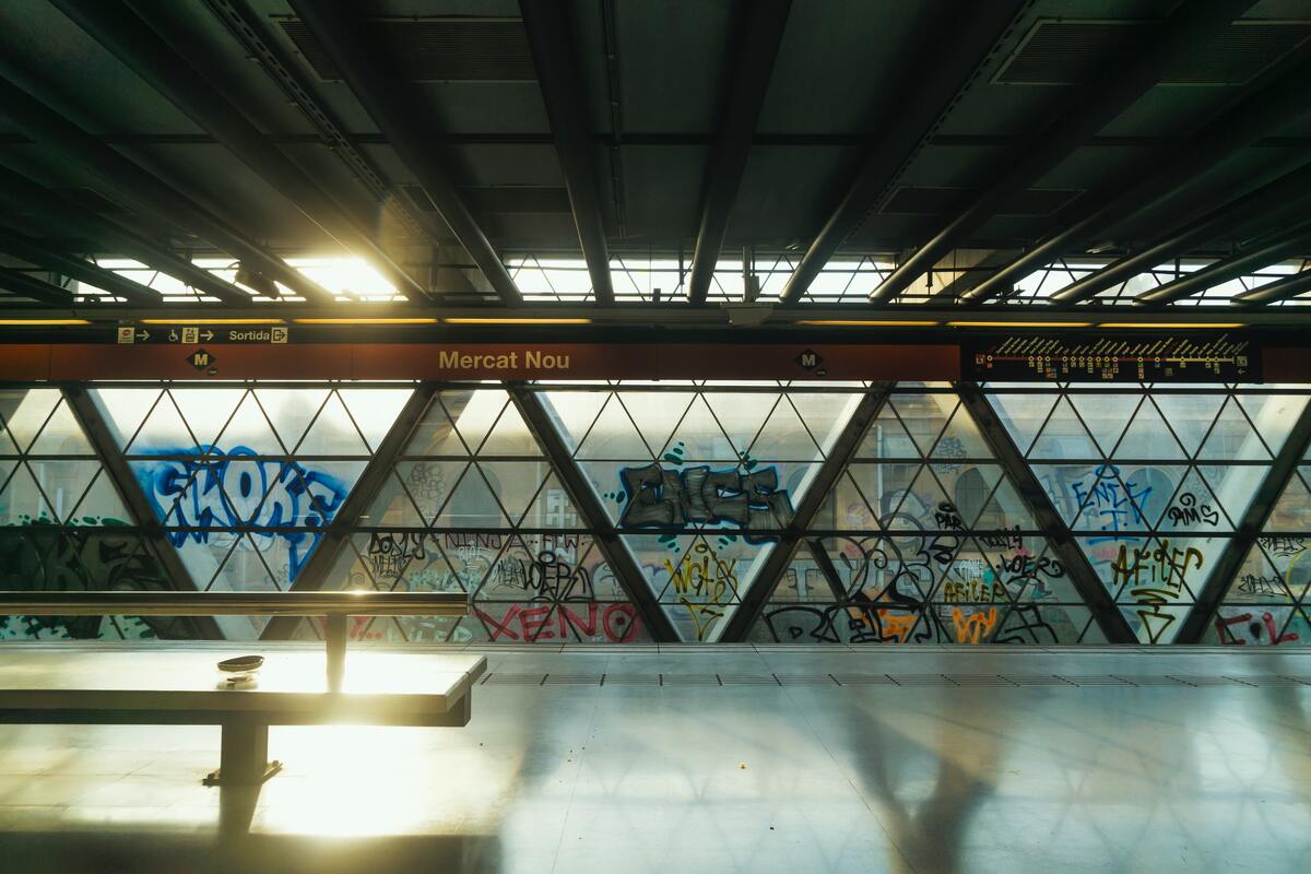 cached/dharmx_walls/architecture/a_room_with_a_table_and_graffiti_on_the_wall.jpg