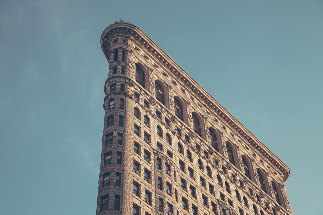 cached/dharmx_walls/architecture/a_tall_building_with_many_windows_with_Flatiron_Building_in_the_background.jpg