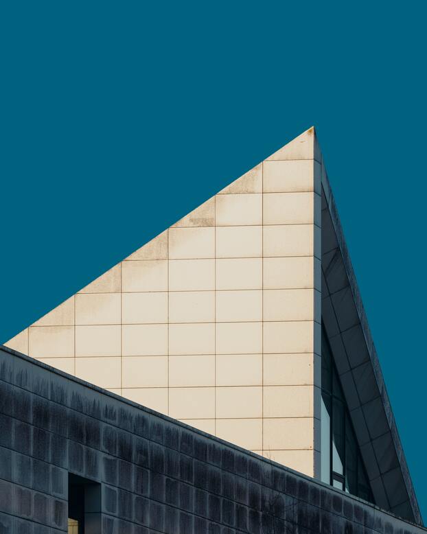 cached/dharmx_walls/architecture/a_triangular_building_with_a_blue_sky.jpg