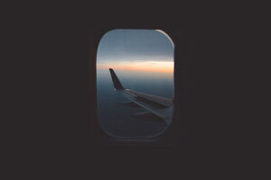 cached/dharmx_walls/centered/an_airplane_wing_seen_through_a_window.jpg