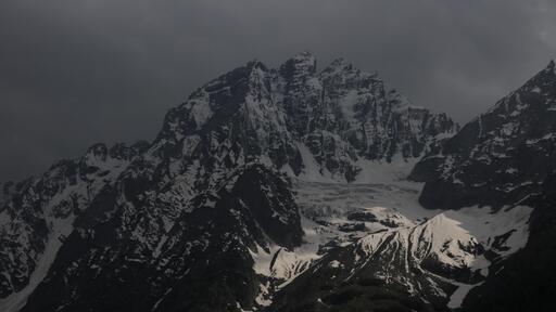 cached/dharmx_walls/cold/a_snowy_mountain_with_dark_clouds.jpg