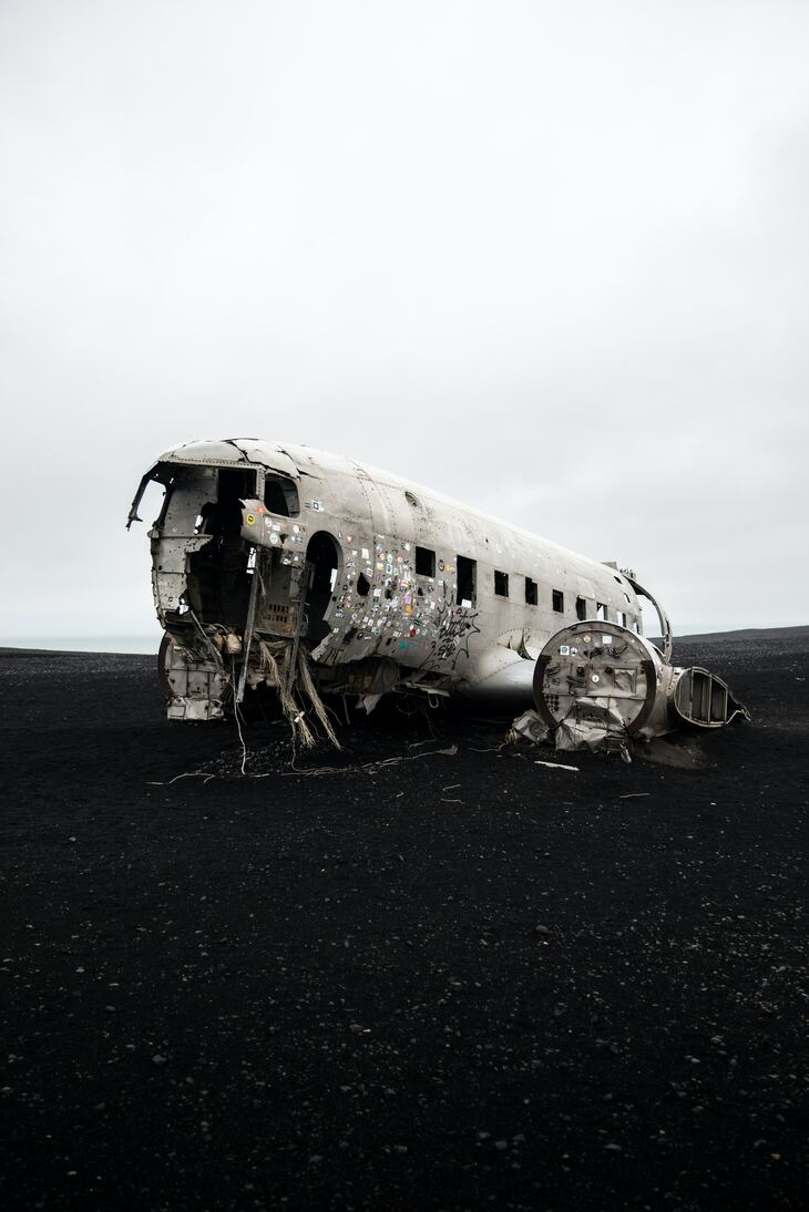 cached/dharmx_walls/decay/an_airplane_that_has_been_crashed_on_a_black_sand_beach.jpg