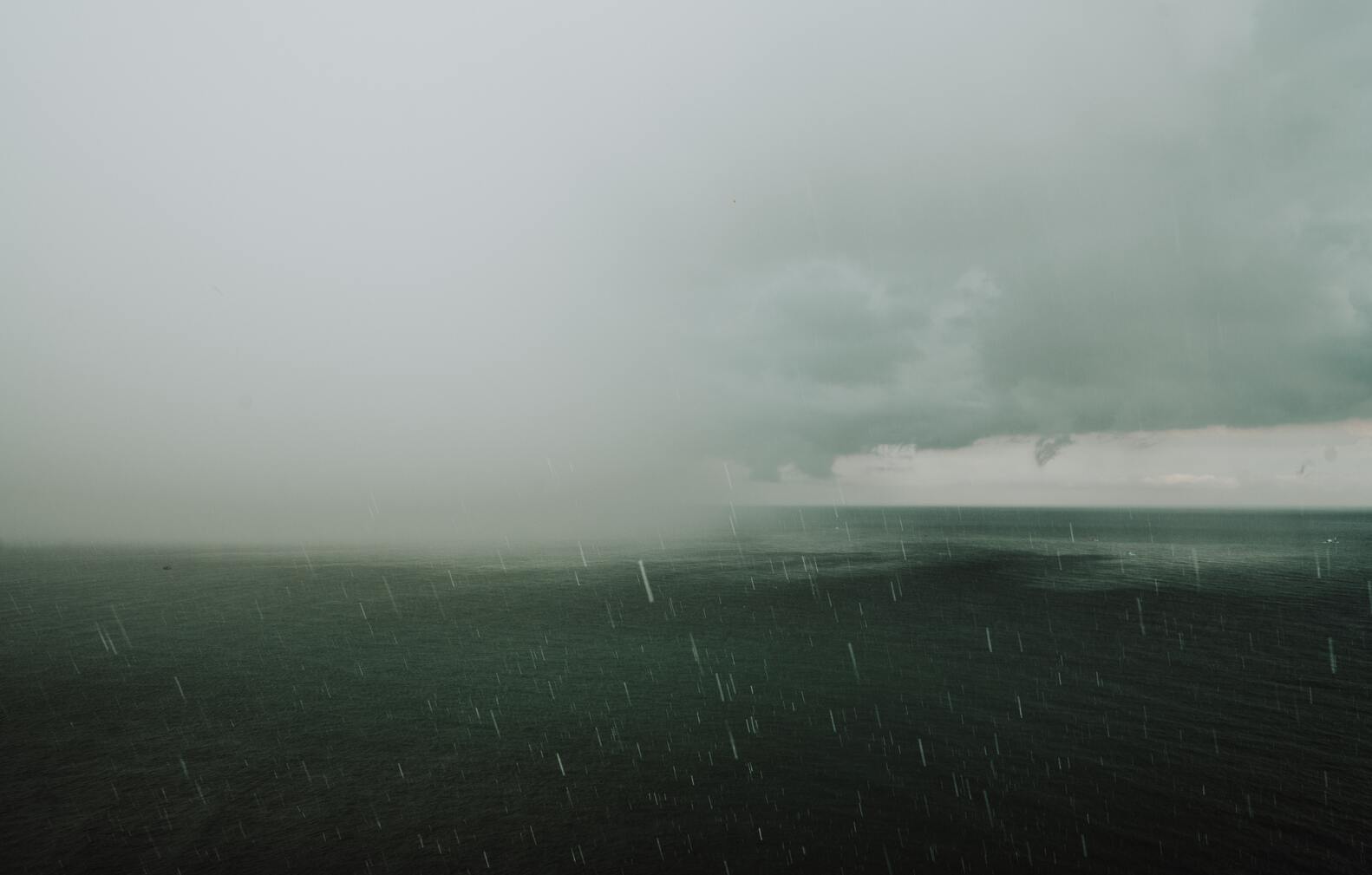 cached/dharmx_walls/dreamcore/a_body_of_water_with_rain_falling_on_it.jpg