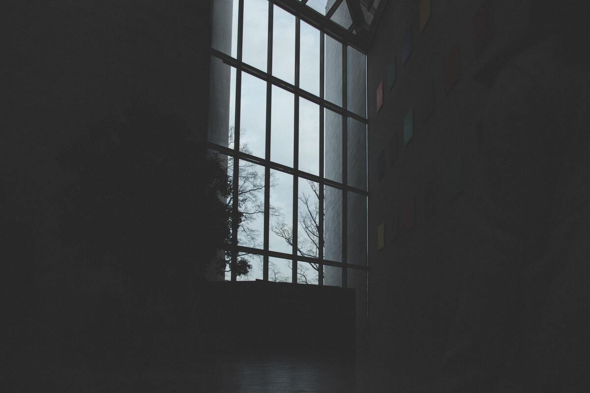 cached/dharmx_walls/dreamcore/a_dark_room_with_a_large_window.jpg