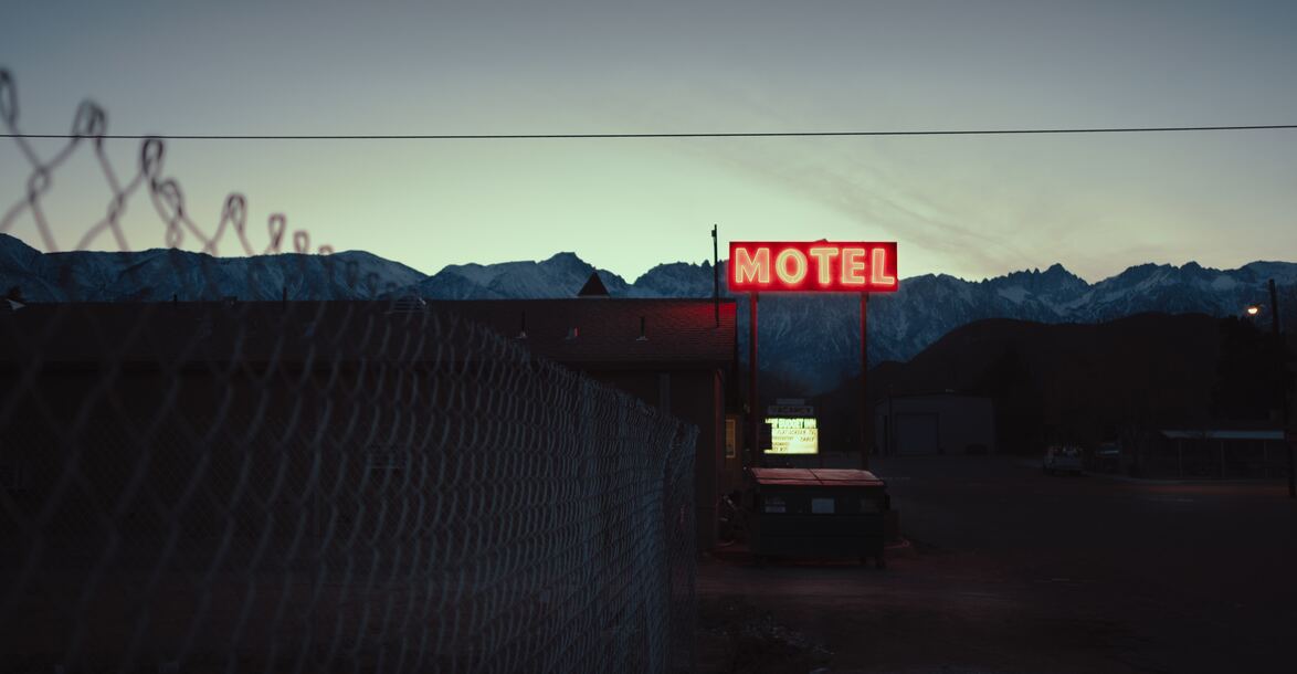 cached/dharmx_walls/dreamcore/a_motel_sign_with_a_snowy_mountain_in_the_background.jpg