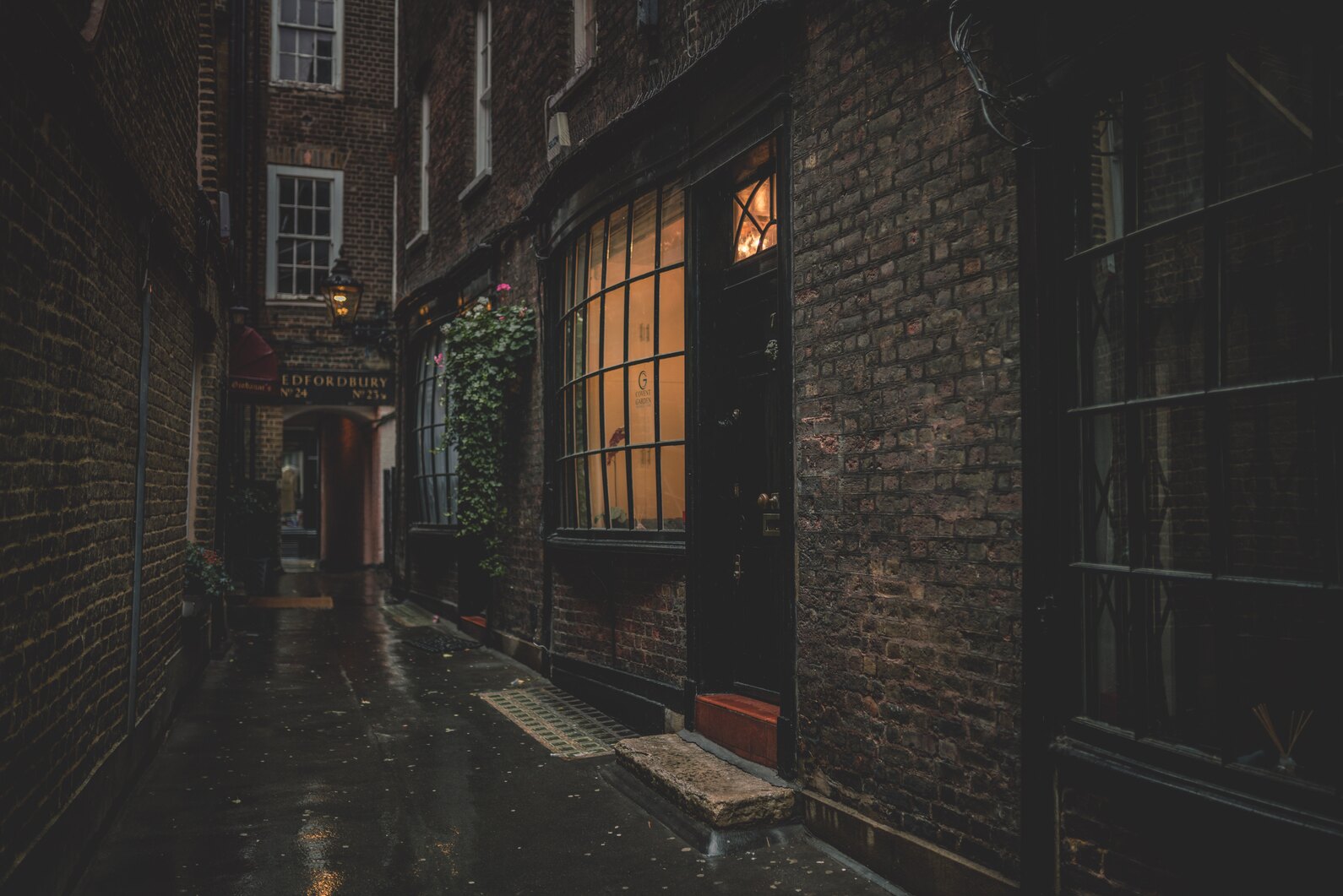 cached/dharmx_walls/gruvbox/a_dark_alleyway_with_a_brick_building_and_a_window.jpg