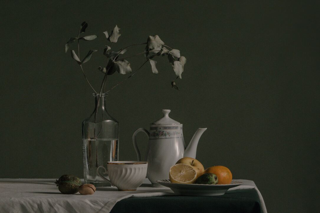 cached/dharmx_walls/interior/a_table_with_a_vase_of_fruit_and_a_pitcher_of_water.jpg