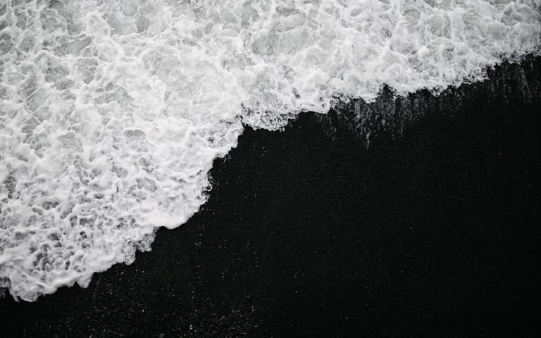 cached/dharmx_walls/monochrome/a_black_sand_with_white_foamy_waves.png