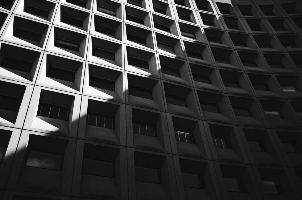 cached/dharmx_walls/monochrome/a_building_with_many_square_windows.jpg