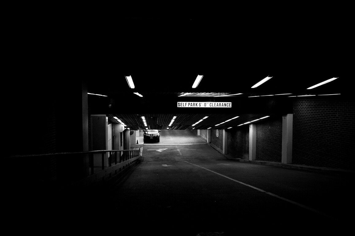 cached/dharmx_walls/monochrome/a_car_in_a_parking_garage.jpg