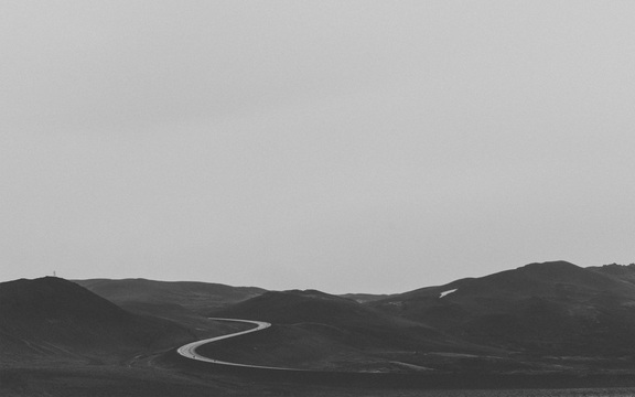 cached/dharmx_walls/monochrome/a_road_going_through_a_desert.jpeg