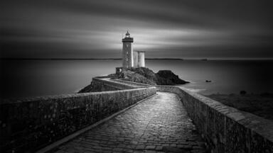 cached/dharmx_walls/monochrome/a_stone_walkway_leading_to_a_lighthouse.jpg