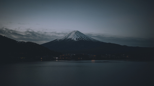cached/dharmx_walls/mountain/a_mountain_with_snow_on_top_and_a_body_of_water_01.jpg