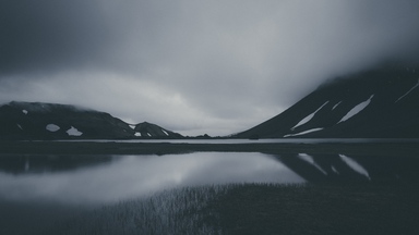 cached/dharmx_walls/nature/a_lake_with_snow_covered_mountains_in_the_background.jpg