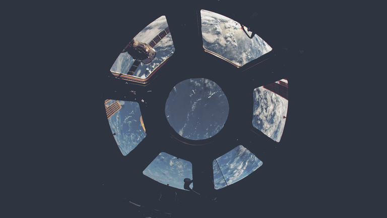 cached/dharmx_walls/nord/a_view_of_earth_from_a_space_station.png