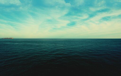 cached/dharmx_walls/solarized/a_large_body_of_water_with_clouds_in_the_sky.jpg