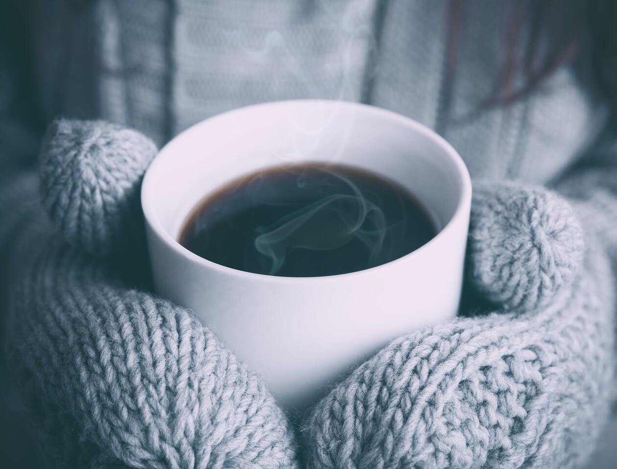 cached/dharmx_walls/unsorted/a_person_holding_a_cup_of_coffee.jpg
