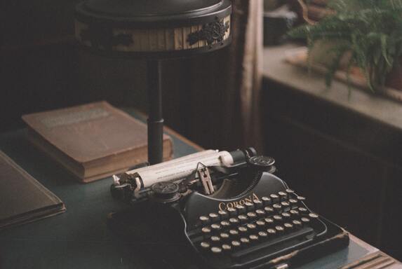 cached/dharmx_walls/unsorted/a_typewriter_on_a_table.jpg