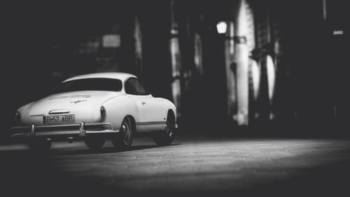 cached/dharmx_walls/unsorted/a_white_car_parked_on_a_brick_road.png